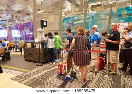 SINGAPORE - CIRCA AUGUST, 2016: people queue at Singapore Changi Airport. Changi Airport is one of the largest transportation hubs in Southeast Asia.
