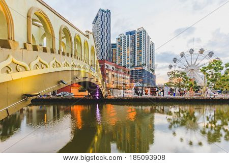 MALACCA, MALAYSIA - AUGUST 13, 2016: An arch bridge over the Malacca river near Jambatan Old Bus Station. Malacca City was listed as a UNESCO World Heritage Site on 7 July 2008