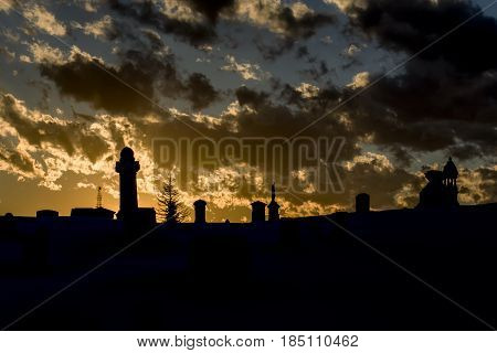 Silhouetted Cemetery on a hill in Massachusetts at sunset.