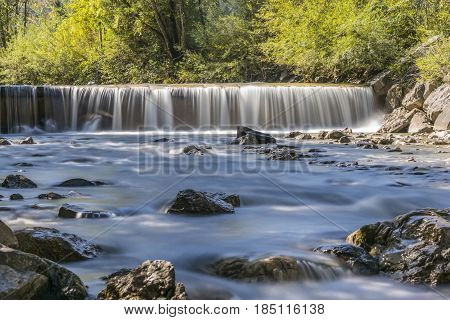 Long exposure of a waterfall on a clear day in the Alps