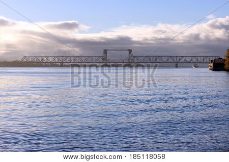 white cumulus clouds pass bridge over the Northern Dvina River.