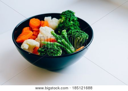 Fresh vegetables broccoli, carrots, cauliflower steamed. Healthy lifestyle, vitamins. On a white background. Vegetarian