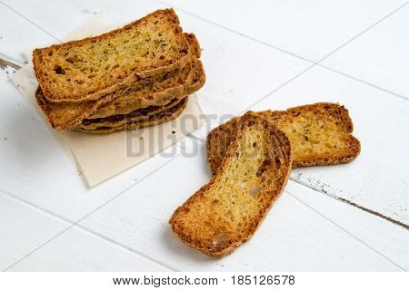 Crostini without toppings on a white background. A crostino is a small slice of toasted or grilled bread used in Italian cuisine for appetizers. It's an healthy food a versatile snack to eat just plain with vegetables cheeses or meats!