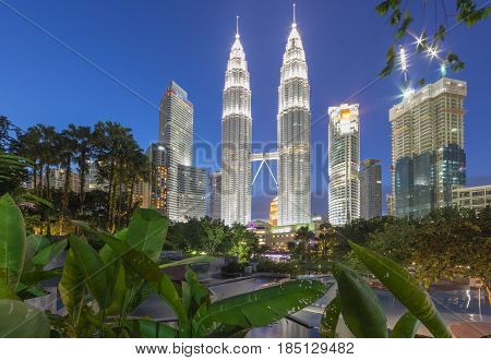 KUALA LUMPUR MALAYSIA - AUGUST 13: Petronas Twin Towers in blue hour on August 13, 2016 in Kuala Lumpur. Petronas Twin Towers were the tallest buildings (452 m) in the world from 1998 to 2004