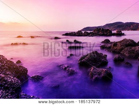 Seascape landscape nature in twilight and rock with colorful of sunset long exposure technique