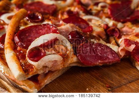 Junk food, bad habits. Pizza sliced on rustic wooden table background. Italian traditional meal, unhealthy eating, dining concept