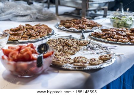 Stack of mini Pizza on plates at the buffet during a business meeting