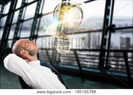 Businessman looks a big light bulb in his office. Great business idea concept