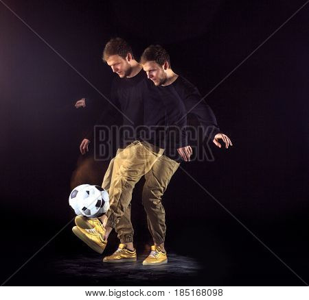 A portrait of a fan with ball on gray studio background. Freestile concept. Stroboscope shooting technique