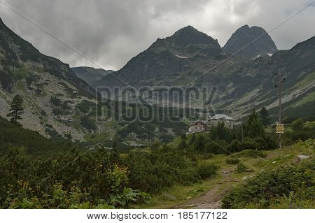 Mountain overgrown with coniferous forest, glade and rest-house toward Maliovitza peak in Rila 

mountain, Bulgaria