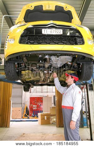 Portrait Of An Auto Mechanic At Work On A Car