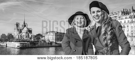 Mother And Child Tourists On Embankment Near Notre Dame De Paris