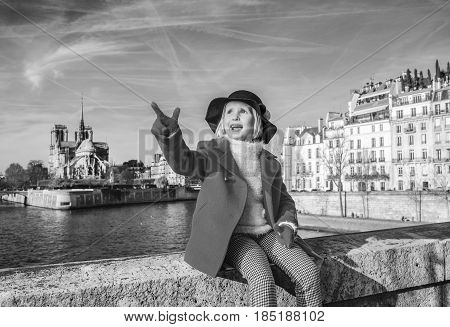 Child On Embankment Near Notre Dame De Paris In Paris, France