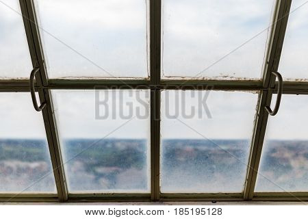 View of the old dirty frosted roof top window.