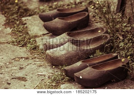 Regional tradition and culture handmade concept. Wooden dutch shoes traditional clogs footwear standing in row