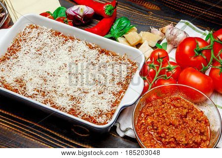 Preparation of homemade lasagna. Italian pasta recipe with tomato sauce and minced meat.