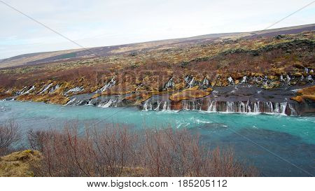 Hraunfossar Horizontal Waterfall In Icealand. Beautiful And Majestic Landscape Tourist Attraction Pl