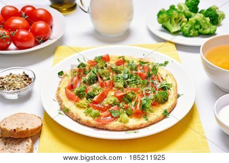 Breakfast with fried eggs. Omelet with vegetables on plate
