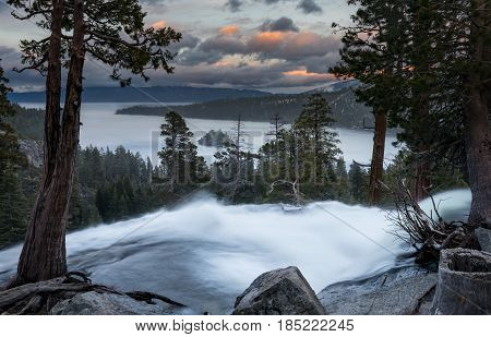 Sunset at Emerald Bay on Lake Tahoe from the top of Lower Eagle Falls as the torrent of water from snow melt flows into the lake from Sierra Nevada Mountains.