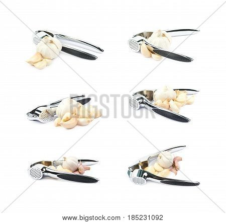 Metal garlic press utensil next to a pile of fresh cloves isolated over the white background, set of six different foreshortenings