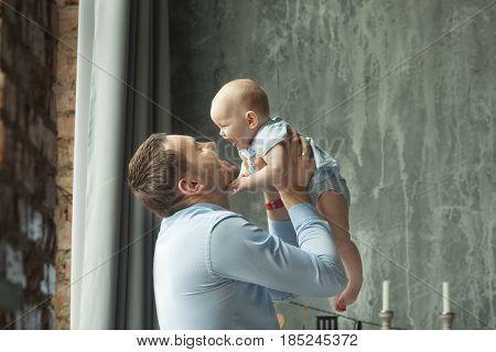 Happy dad with a little daughter of European appearance