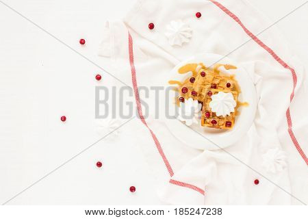 Plate Of Belgian Waffles With Caramel, Meringue And Berry On White Background. Flat Lay, Top View