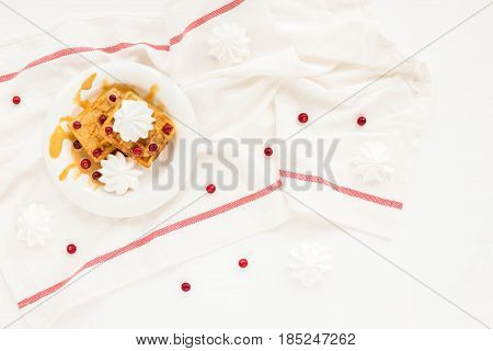 Plate Of Belgian Waffles With Caramel, Meringue And Berry On White Background. Flat Lay, Top View