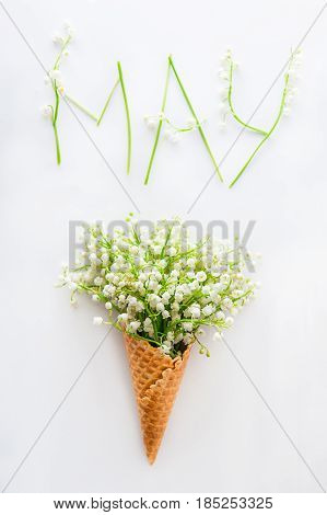 White Card With Word May - Letters Made Of Flowers And Leaves, And Bouquet Of Lilies Of The Valley (