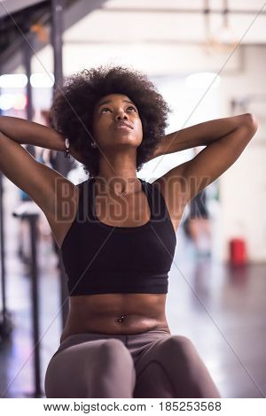 young fit african american woman doing sit ups in fitness studio at the gym.Abdominal exercises Sit up