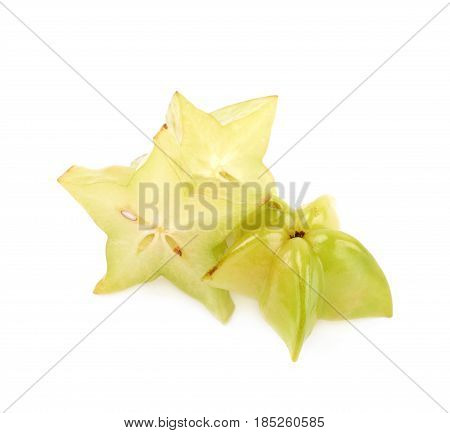 Pile of sliced carambola starfruit fruits isolated over the white background