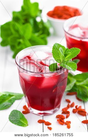 Healthy detox drink with goji berries infused in water with ice cold refreshing beverage