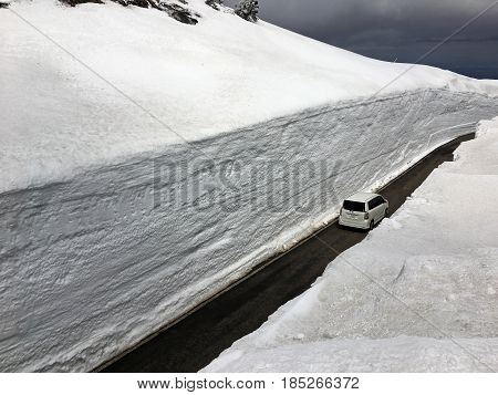 ZAO ECO LINE JAPAN - APRIL 22 2017: Car on the road in a snow tunnel in the Zao mountain range