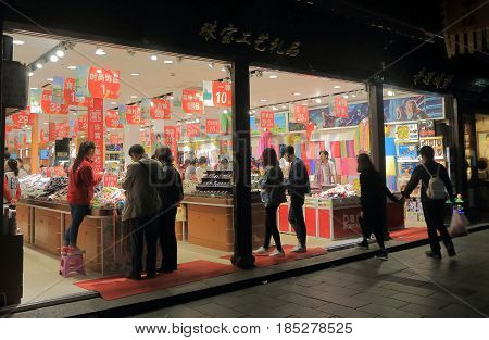 HANGZHOU CHINA - NOVEMBER 5, 2016: Unidentified people visit silk shop on Qing He Fang historical street. is a protected area of the historical buildings from the Ming and Qing dynasty.