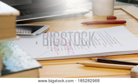 proofreading text on table in office with office supplies