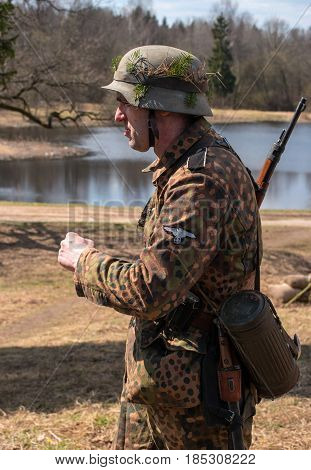 Gatchina, Russia - May 7, 2017: Historical reconstruction of the battles of World War II. A participant in the reconstruction in the form of a Wehrmacht soldier before the start of the battle.