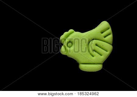 Dog biscuit on black background to connote a concept of feeding animals