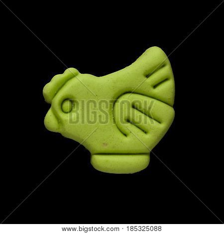 Dog biscuit on black background to connote a concept of feeding animals