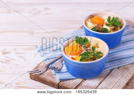 Eggs En Cocotte Baked With Spinach, Parsley And Cream.