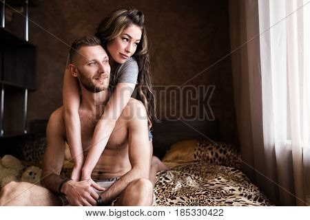 Love story in bed. Beautiful sensual couple