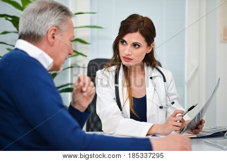 Doctor talking to her patient during a visit