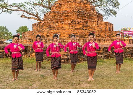 KALASIN THAILAND - FEBRUARY 20 2016: Girl dancers with local dress doing Thai Northeastern traditional dance at Yaku Pagoda to celebrate Buddism event in Kalasin