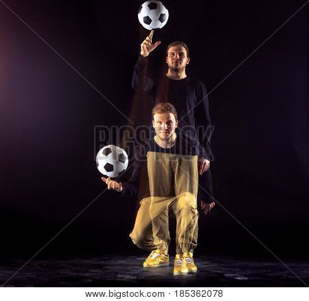 A portrait of a fan with ball on gray studio background. Freestile concept. Stroboscope shooting technique