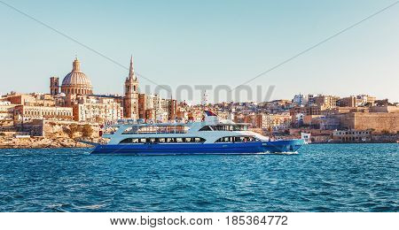 Valletta citiscape with bay cruise boat Malta