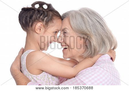 Portrait of grandmother and little granddaughter on white background