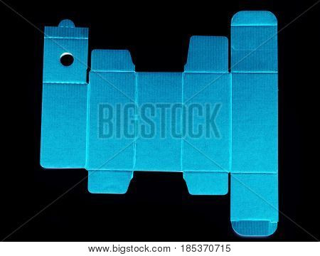 Real view of die line template of a blue cardboard box against black background