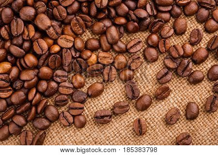 Coffee Beans On Burlap Background. Roasted Coffee Beans Isolated In White Background. Roasted Coffee