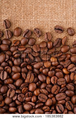 Coffee Beans On Burlap Background. Roasted Coffee Beans Isolated In White Background. Roasted Coffee