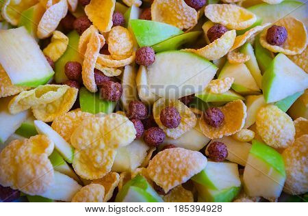 Morning breakfast. Cereal flakes. Cornflakes. Apples are cut into pieces.