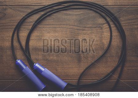 skipping rope for an exercise. skipping rope on the table. skipping rope with purple handles. skipping rope for street workout