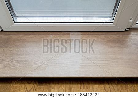 Acetone damaged on wooden doorstep, entrance to terrace